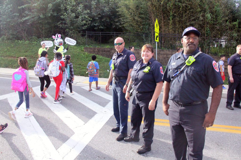 Public safety blocking traffic from a school crosswalk 
