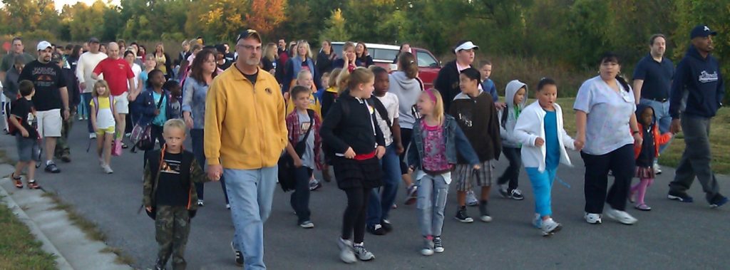 Parents and children walk in the street