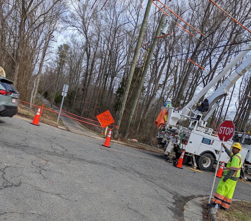 Photo of construction workers blocking access to, and working on, bicycle and pedestrian path.