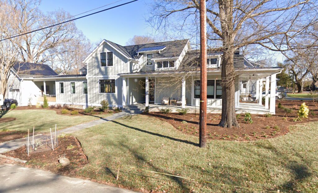 Photo of a long house with a large lawn