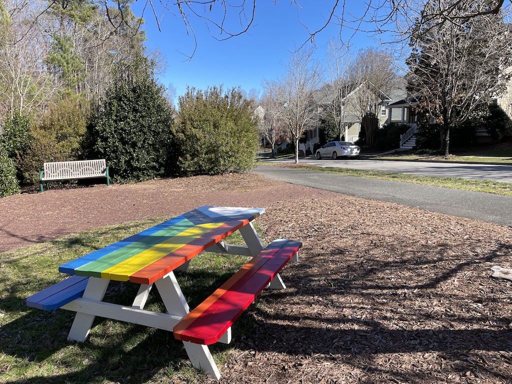 Small pocket park with painted picnic benches