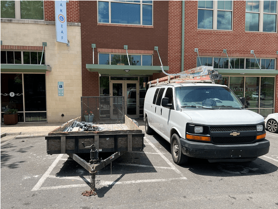 Car and trailer parked in accessible spot in Carrboro, blocking spot for others
