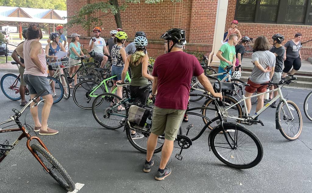 Cyclists looking at art from the Uproar Festival of Public Art