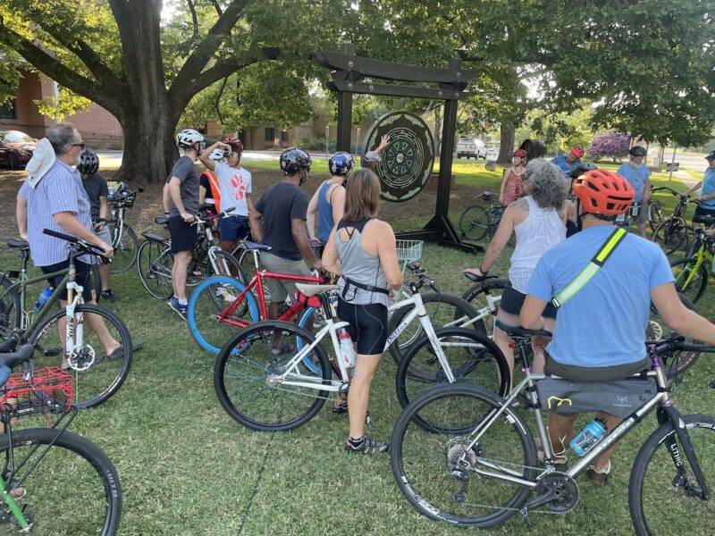 Cyclists looking at art from the Uproar Festival of Public Art