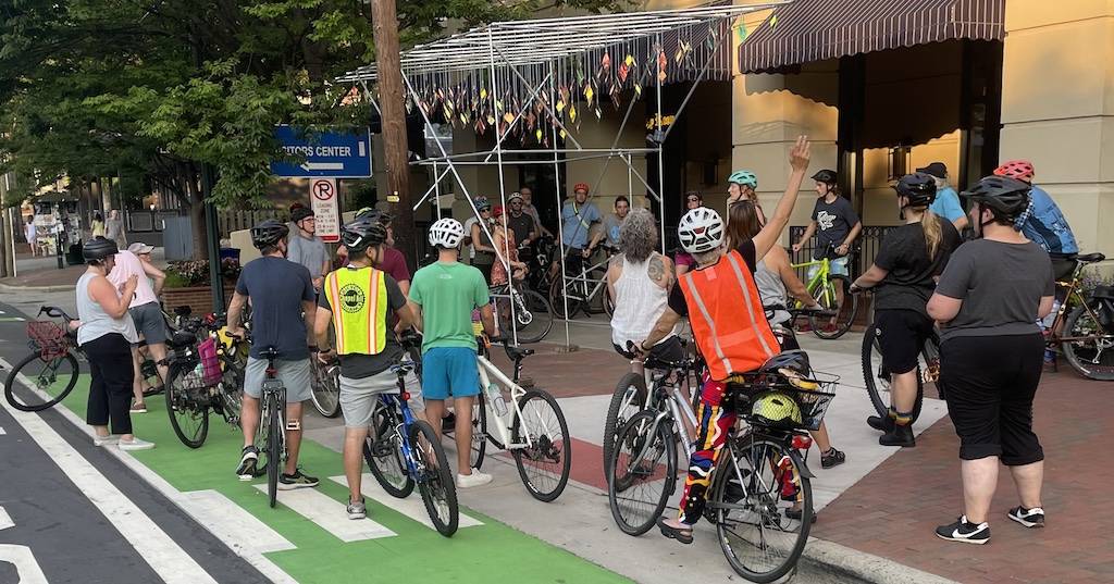 Cyclists looking at art from the Uproar Festival of Public Art