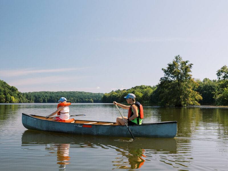 A family canoeing the Cane Creek Reservoir