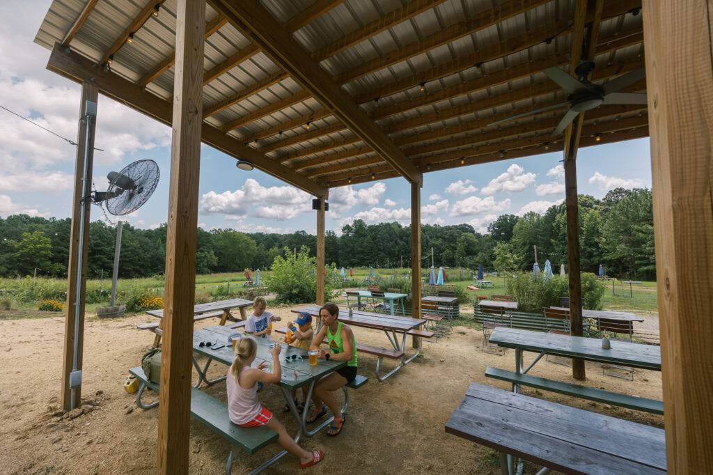 Spacious covered seating with fans at Steel String Brewery at Pluck Farm
