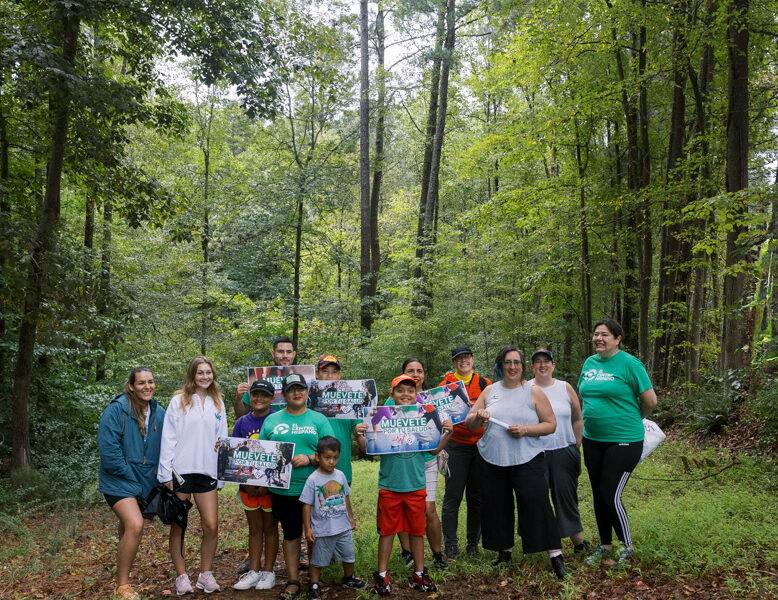 El Centro Hispano and the Carrboro Linear Parks Project explore the sewer easement that will house the future Bolin Creek Greenway