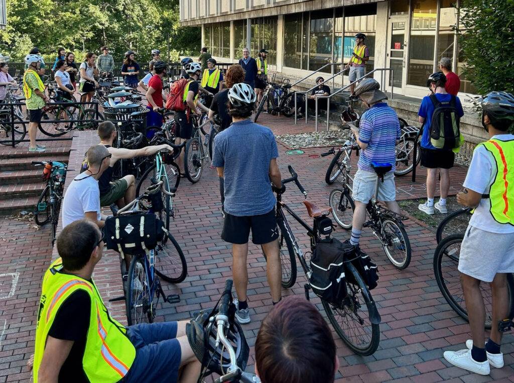 Bike riders receive direction from organizer René in the UNC pit