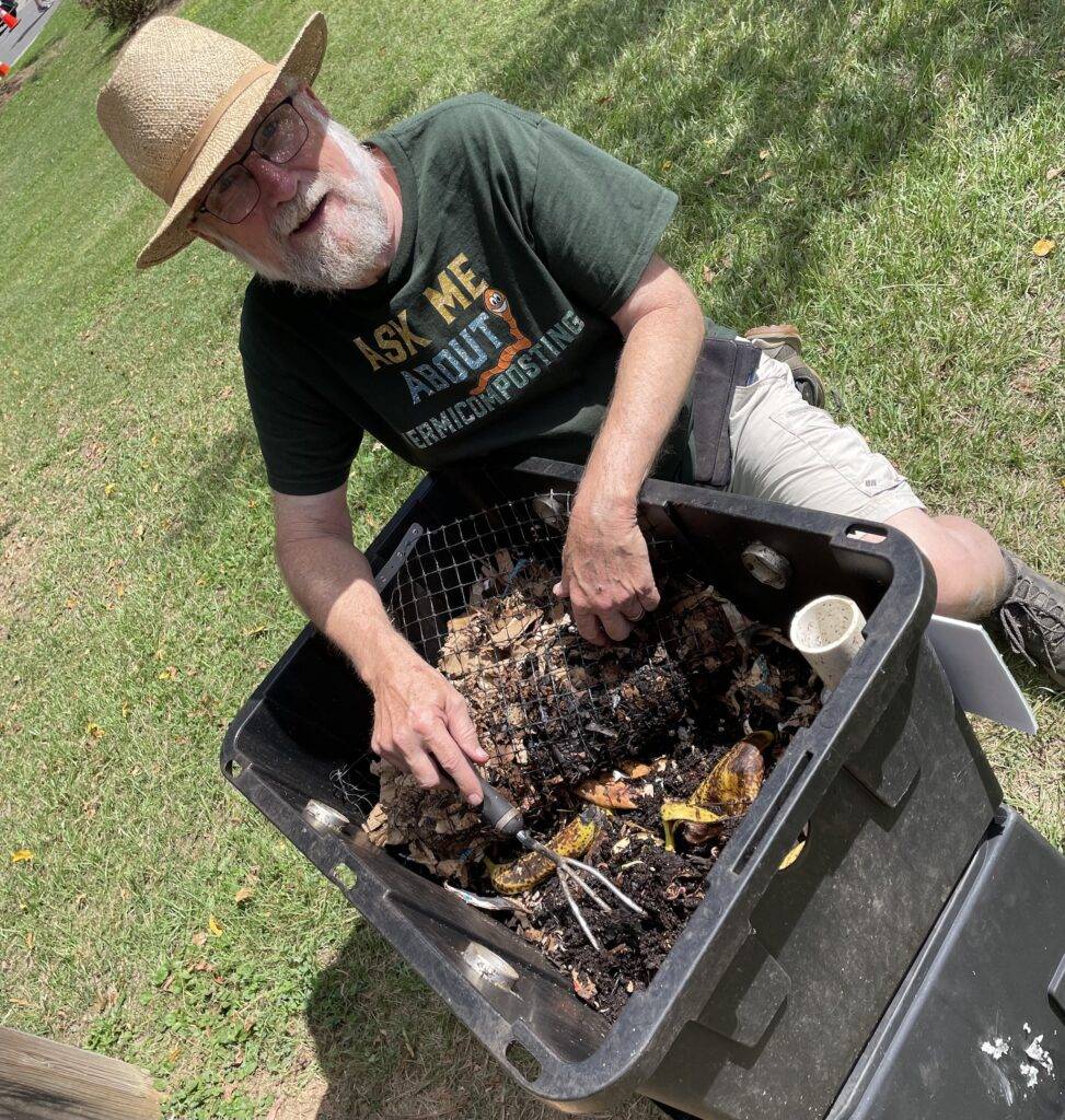 Tom Smith shows off his worm composting bin at the Carrboro Music Festival 