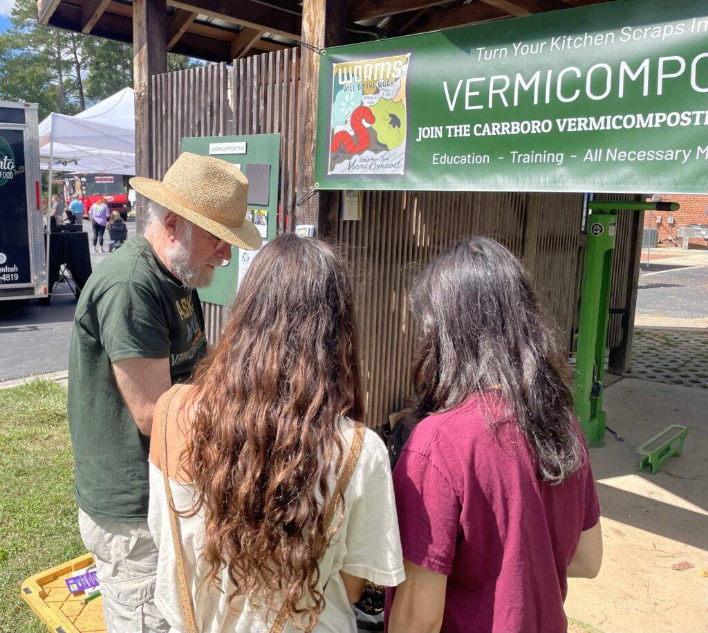 Tom Smith explains his worm composting bin at the Carrboro Music Festival 