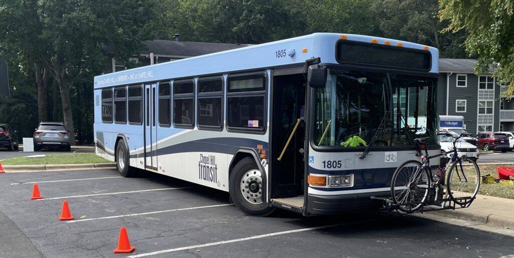 A chapel hill transit bus with a bike on the front
