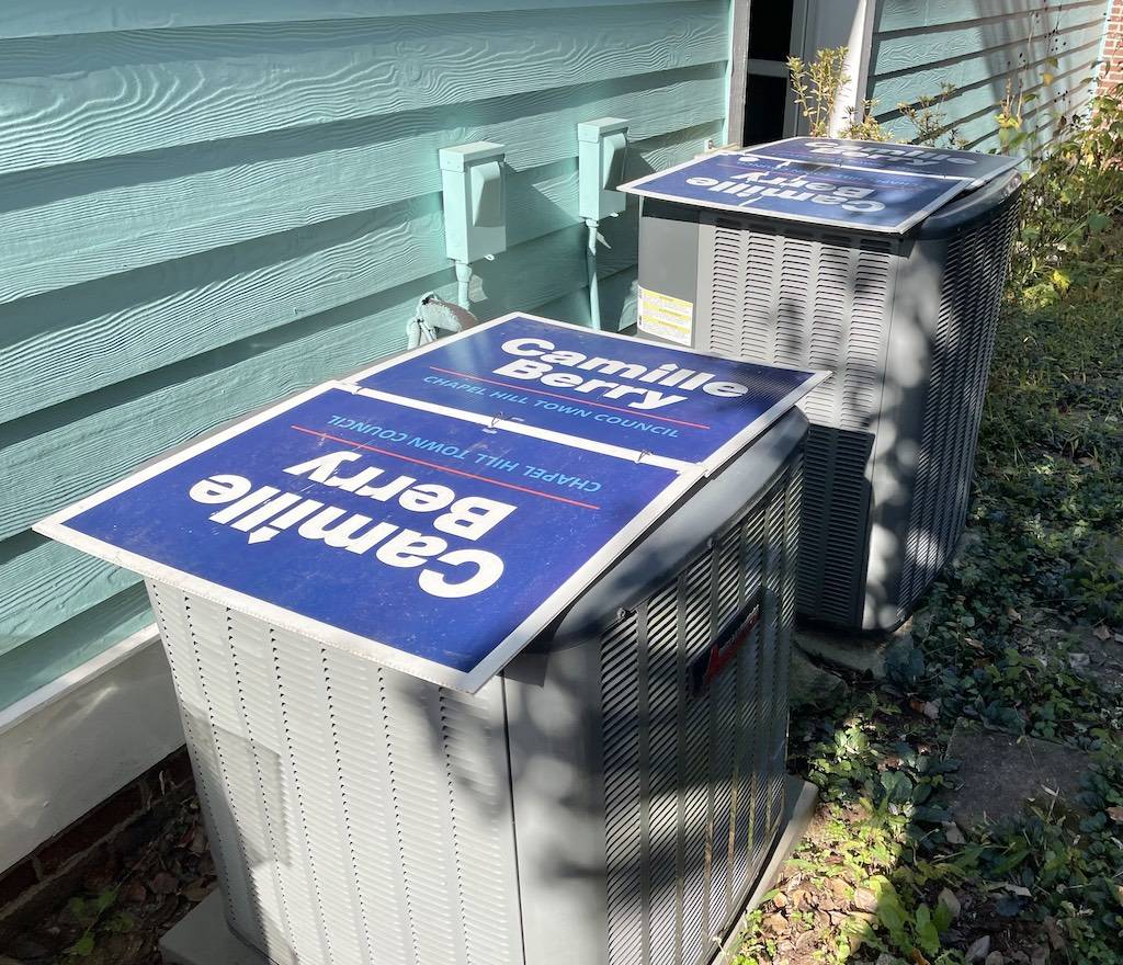 Campaign signs attached to the top of air-condition units