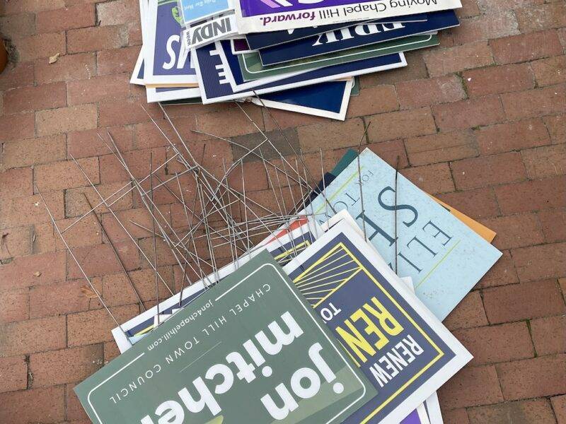 Two piles of campaign signs stacked on bricks