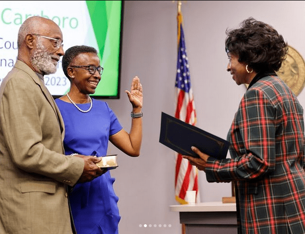 Mayor Barbara Foushee took the oath of office with U.S. Congresswoman Valerie Foushee, and stood beside her husband, Braxton Foushee, who was the first Black member of the Carrboro Town Council elected in 1969.