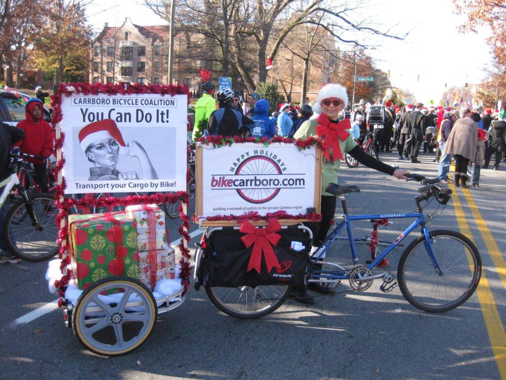 A cyclist and elaborate cargo bike and trailer