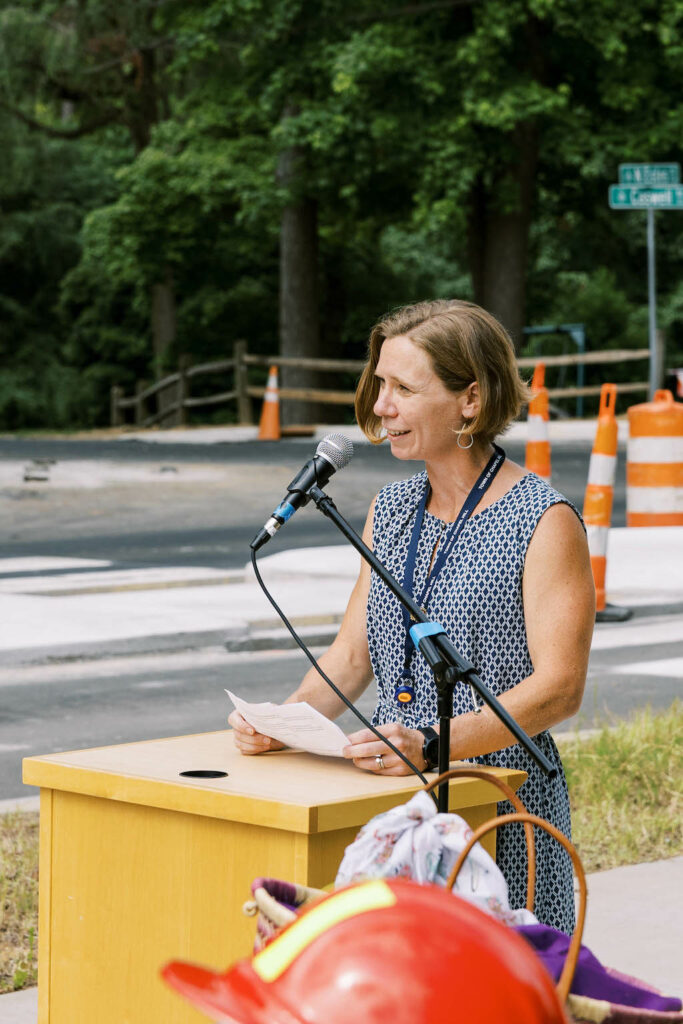 Chapel Hill office of mobility and greenways head Bergen Watterson speaks at the podium of the Estes Drive Ribbon Cutting ceremony