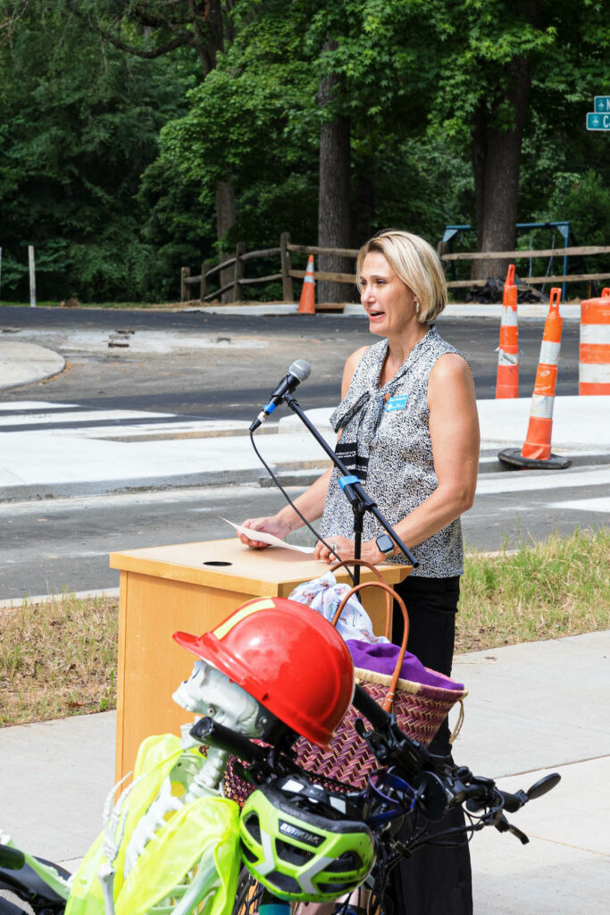 Chapel Hill Mayor Jess Anderson speaks at the podium of the Estes Drive Ribbon Cutting ceremony