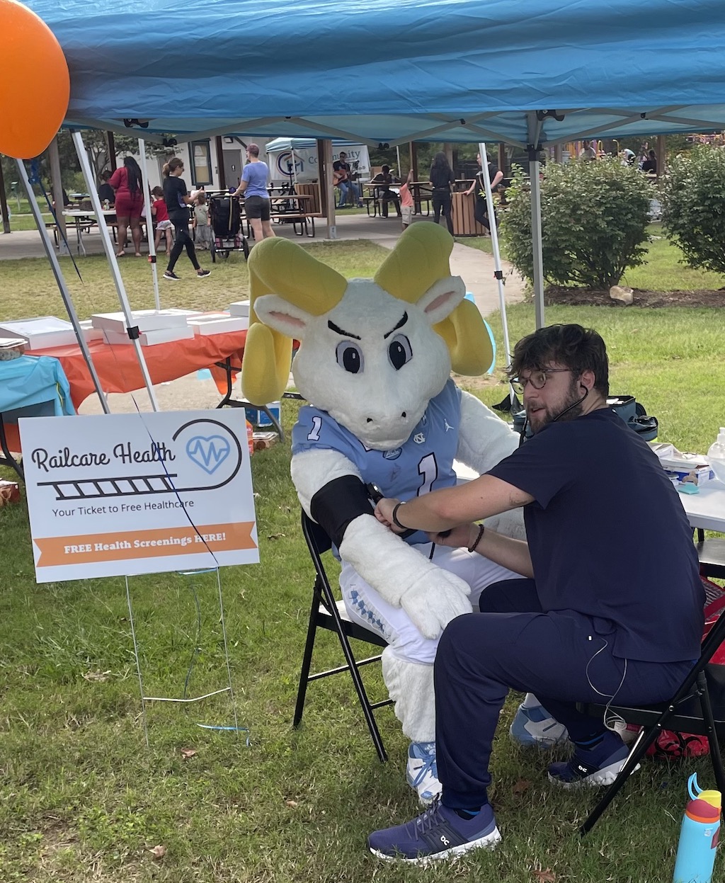 UNC mascot, Rameses , has their blood pressure checked by Alex Bean of Railcare Health