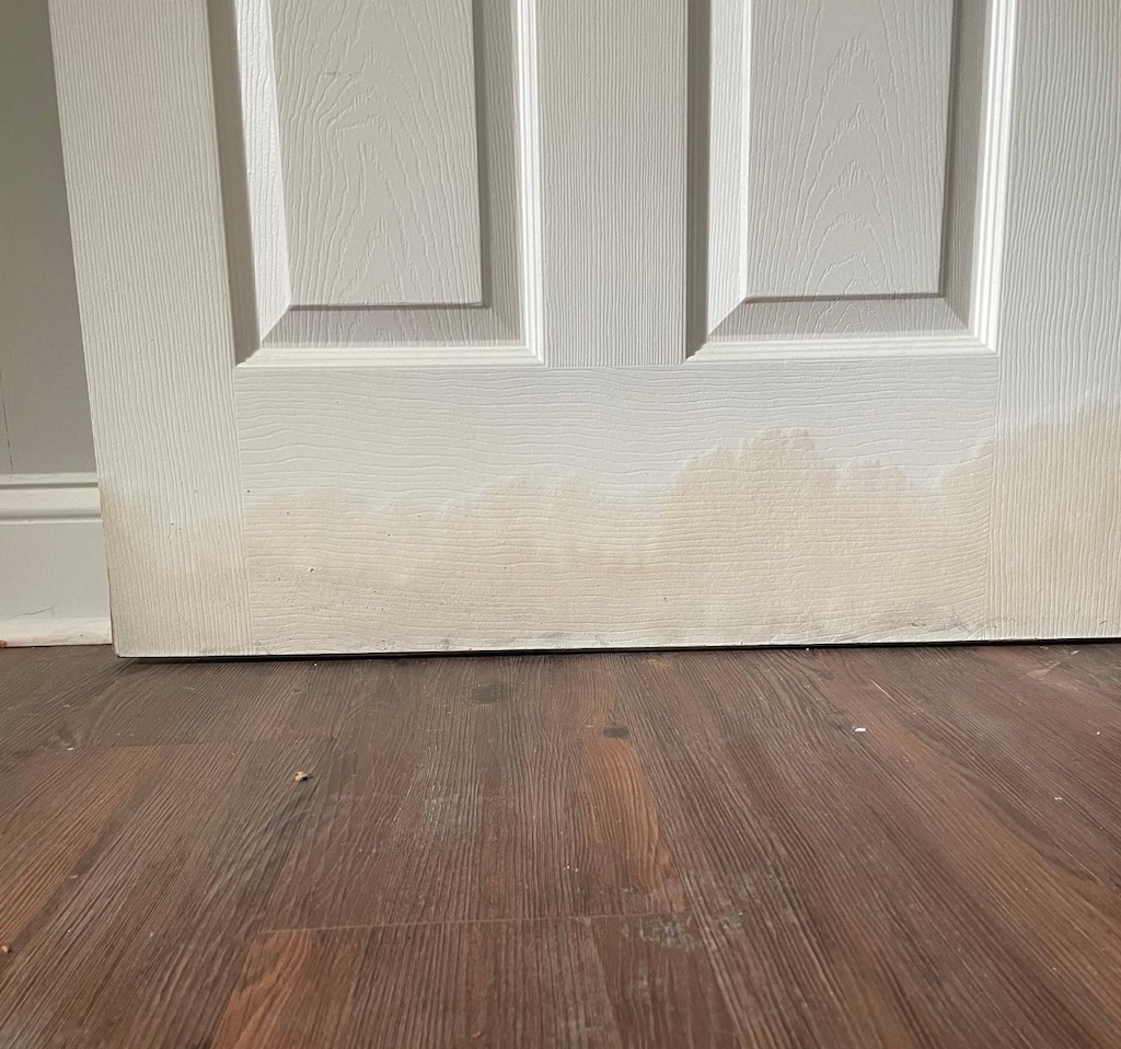 Damaged door in Kingswood, showing the advance of flood waters