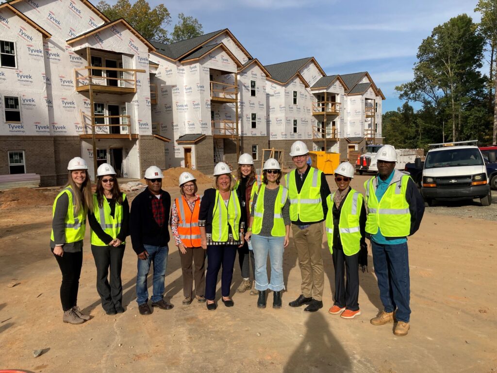 A photo of elected officials outside Perry Place as it was under construction