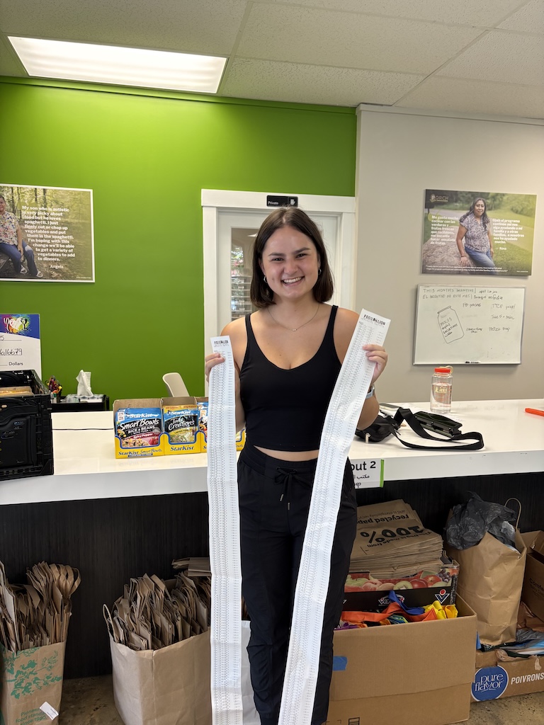 PORCH volunteer, Madi Lin, holding receipts for tuna packets that PORCH purchased thanks to the help of TBB readers!