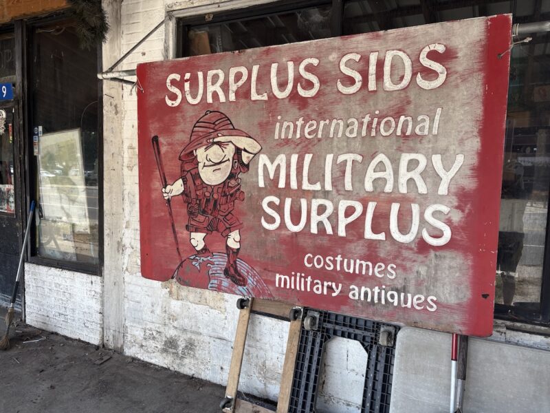 Red sign with the name 'Surplus Sids" on it
