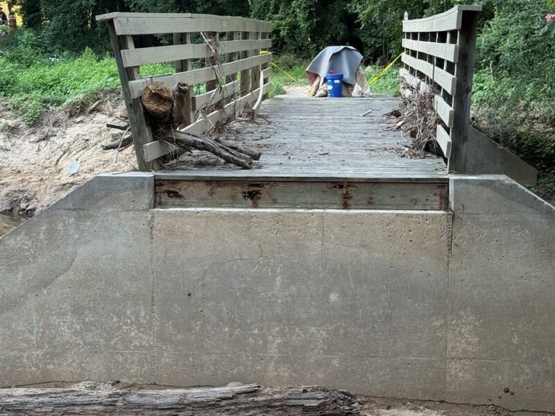Photo of damage along the Fordham Boulevard greenway in Chapel Hill, showing the approach to a bridge over Bolin Creek with the approach missing