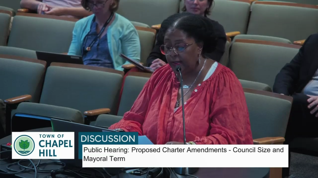 Video still of Danita Mason-Hogans speaking before Chapel Hill Town Council. Text in the chyron underneath states Town of Chapel Hill: Discussion: Public Hearing: Proposed Charter Amendments - Council Size and Mayoral term