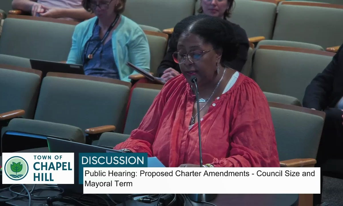 Video still of Danita Mason-Hogans speaking before Chapel Hill Town Council. Text in the chyron underneath states Town of Chapel Hill: Discussion: Public Hearing: Proposed Charter Amendments - Council Size and Mayoral term