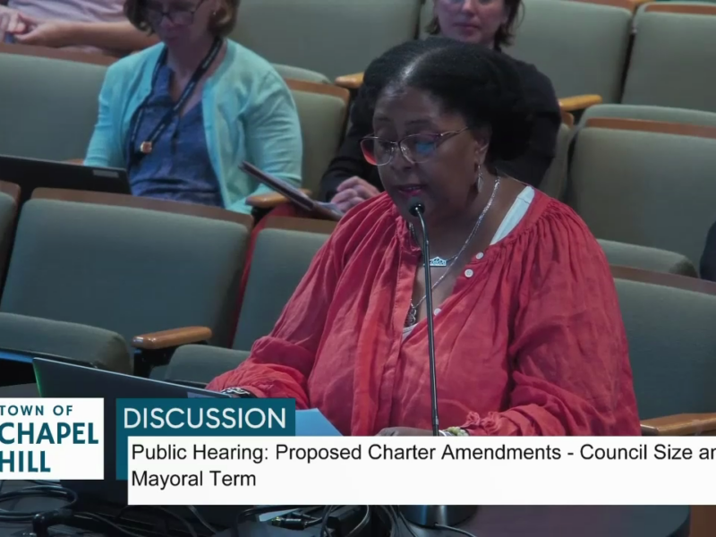 Video still of Danita Mason-Hogans speaking before Chapel Hill Town Council. Text in the chyron underneath states Town of Chapel Hill: Discussion: Public Hearing: Proposed Charter Amendments - Council Size and Mayoral term