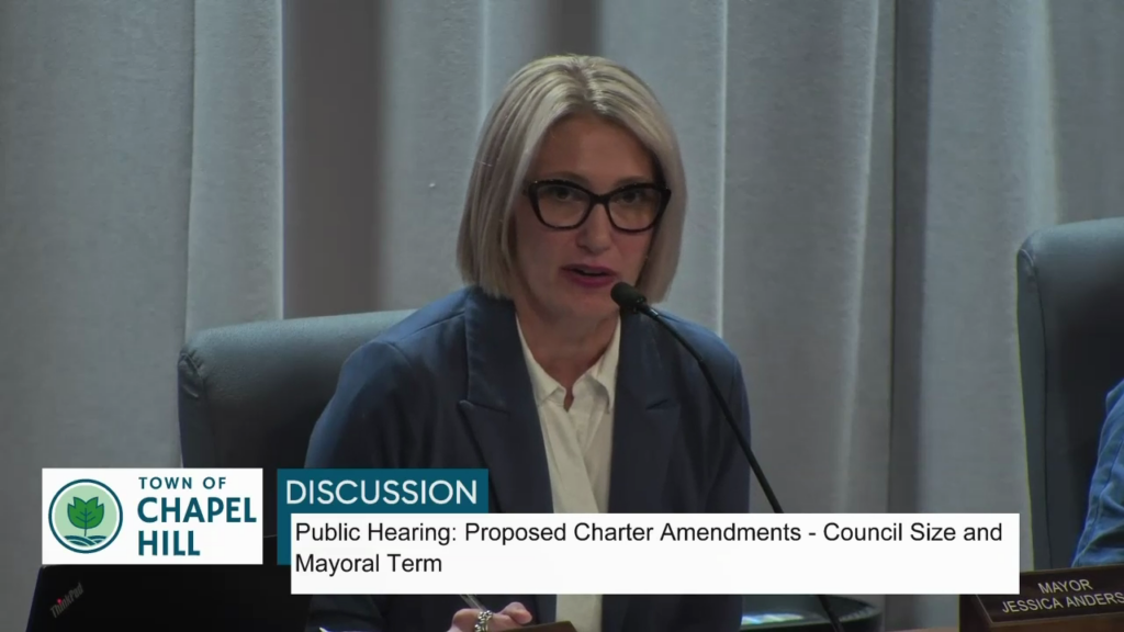 Video still of Jess Anderson, Chapel Hill mayor, speaking before Town Council. Text in the chyron underneath states Town of Chapel Hill: Discussion: Public Hearing: Proposed Charter Amendments - Council Size and Mayoral term