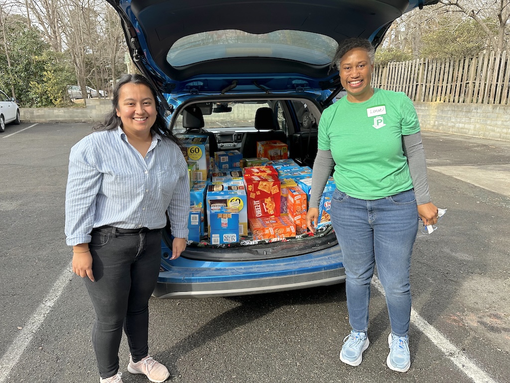 PORCH Chapel Hill-Carrboro Board Chair Lenore Jones-Peretto poses with Chapel Hill High School Social Worker Linda Martinez-Cervantes during PORCH’s Food for Schools snack distribution.